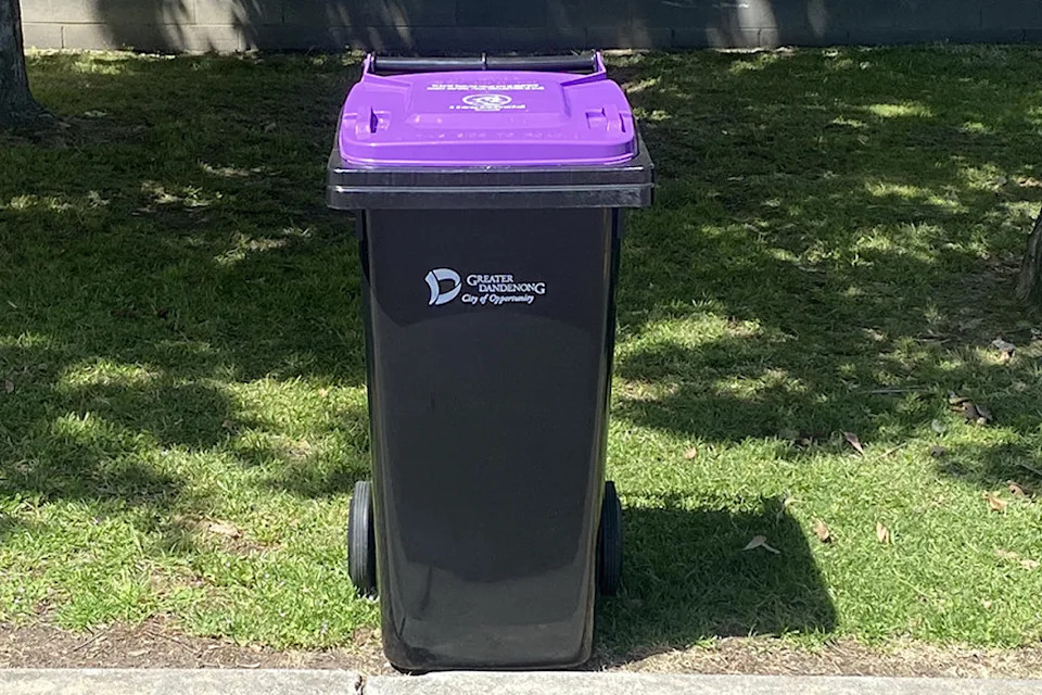 A purple bin on the kerb. 