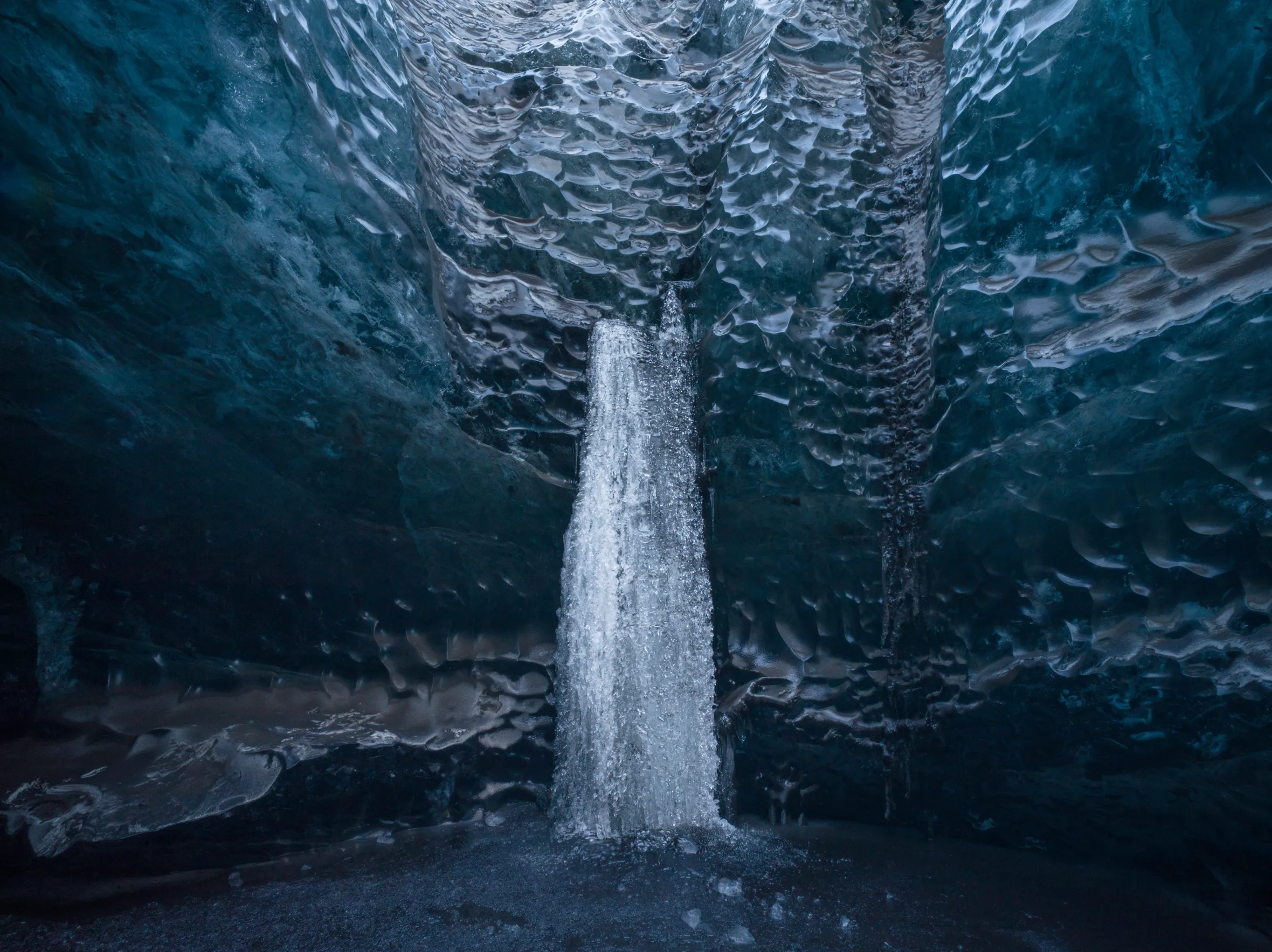 A frozen waterfall inside an Icelandic ice cave.