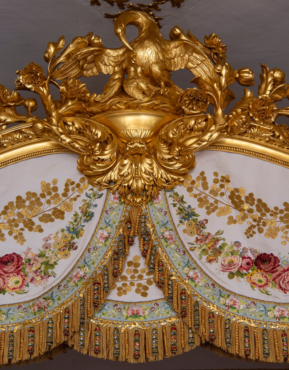 Ornate decorative piece featuring a golden bird and floral patterns.