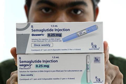 An Indian man holds the boxes for Ozempic and Wegovy treatments