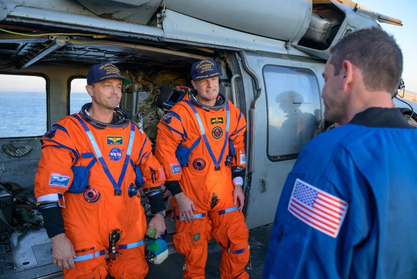 (From left) NASA's Reid Wiseman and CSA's Jeremy Hansen talk with NASA Administrator Jared Isaacman on the flight deck of USS John P. Murtha after splashdown on Friday in the Pacific Ocean off the coast of California.