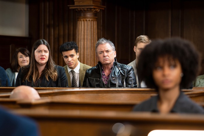 Zoe, Josh, Alfie and Oscar sitting in court as Jasmine stands in the dock in EastEnders