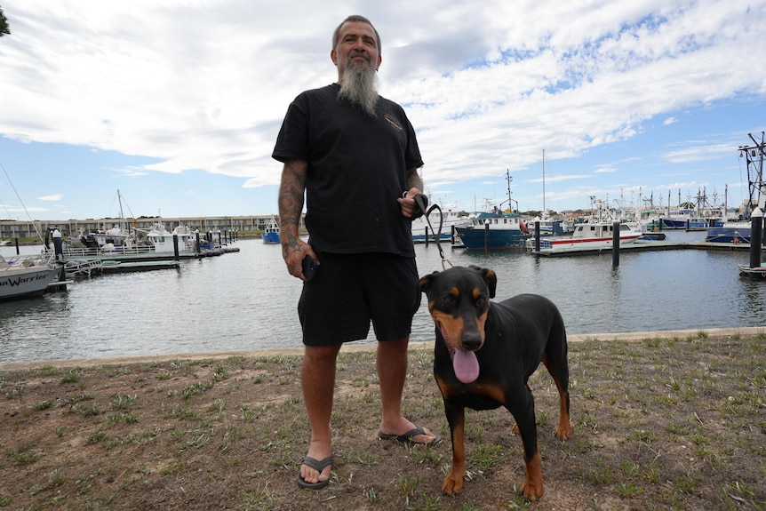 A commercial fisher on the water's edge.