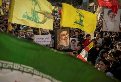 Demonstrators carry portraits of late Hezbollah leader Hassan Nasrallah during a protest against direct negotiations between Israel and Lebanon, in Beirut on Sunday.