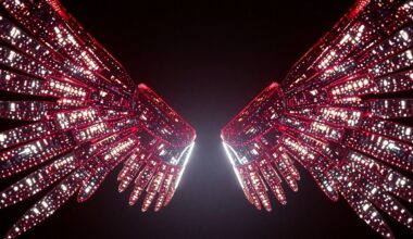 An extreme close-up of shimmering, metallic mechanized wings captured in dramatic studio lighting, conveying the futuristic, high-tech aesthetic of Lisa