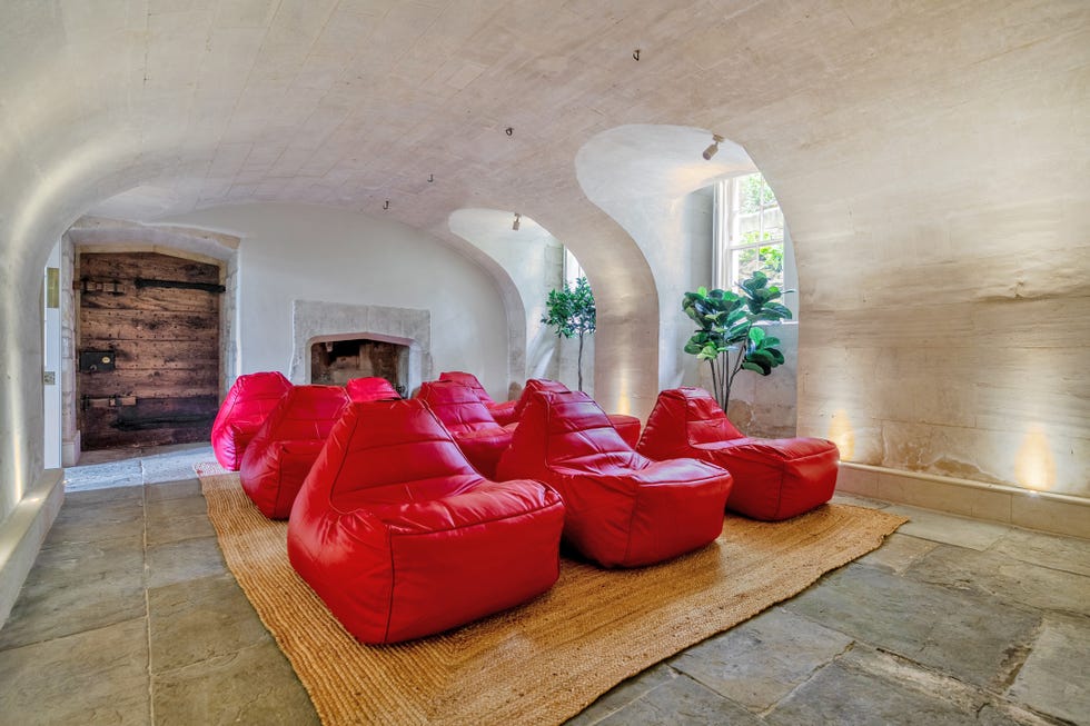A cozy seating area with red bean bag chairs and natural elements.