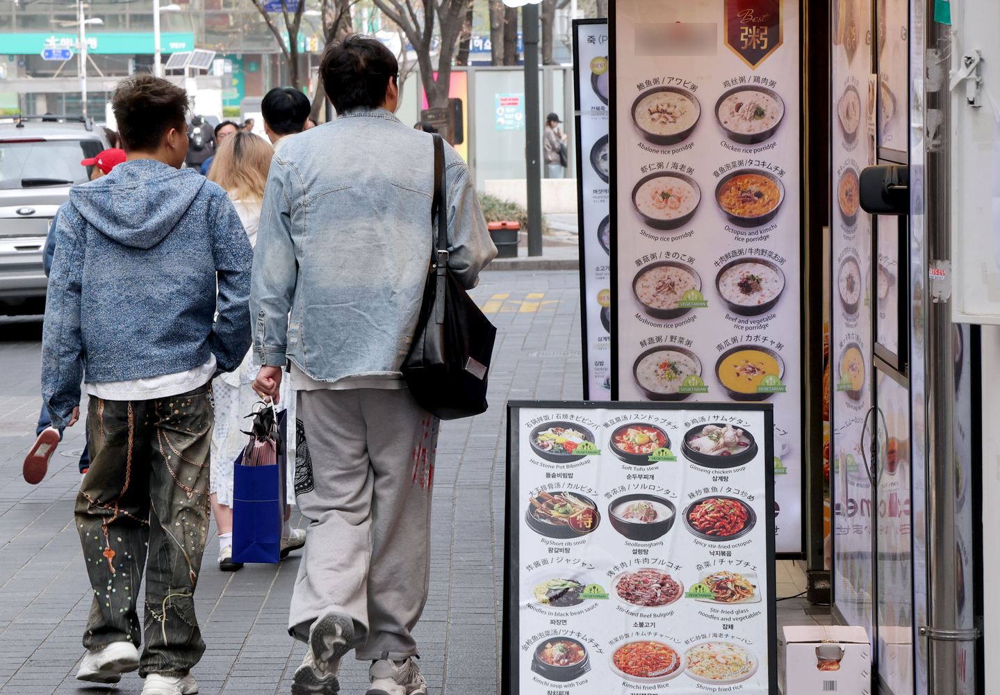 Pedestrians walk past a restaurant in Myeongdong, central Seoul, on April 5. [NEWS1]