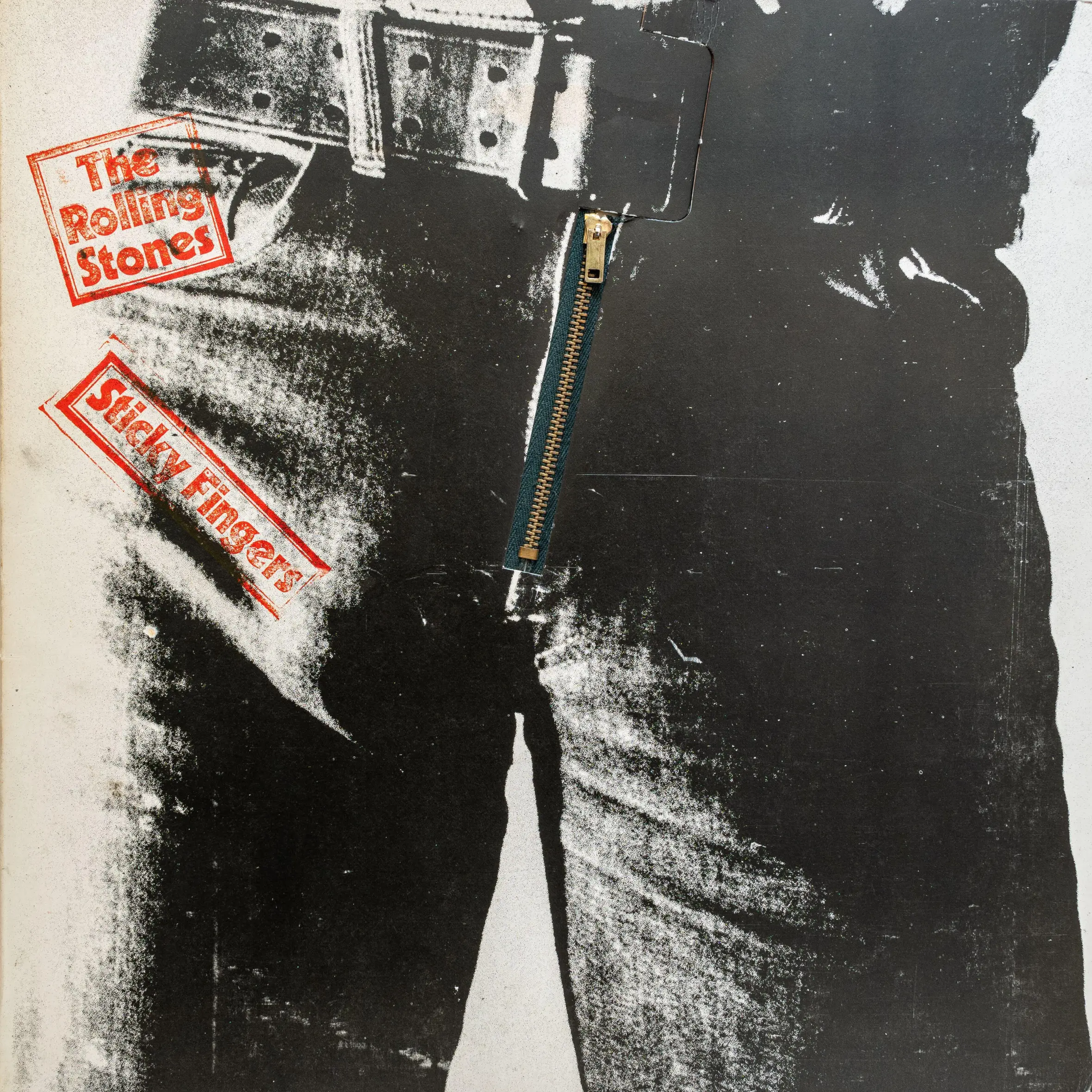 Sticky Fingers album cover by The Rolling Stones, featuring a close-up of denim jeans with a working zipper.