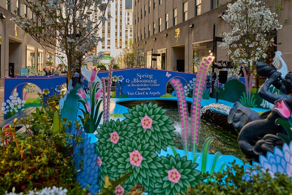 Spring-themed installation at Rockefeller Center featuring decorative flowers and a fountain.