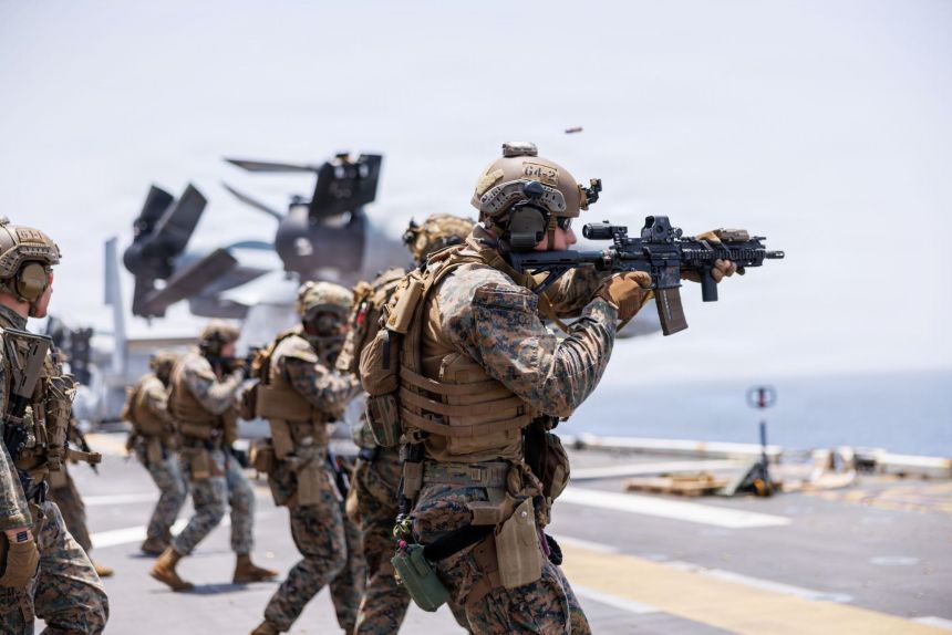 U.S. Marines fire rifles during a deck shoot aboard the forward-deployed amphibious assault ship USS Tripoli, in the U.S. Central Command area of responsibility during Operation Epic Fury, on April 2.