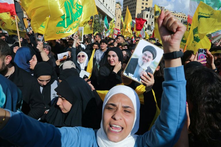 Hezbollah supporters, some waving the party flag and holding up an image of slain Hezbollah leader Hasan Nasrallah, demonstrate near the Governmental Palace to protest the Lebanese authorities' decision to engage in direct negotiations with Israel to end the ongoing war, in downtown Beirut on April 11, 2026. 