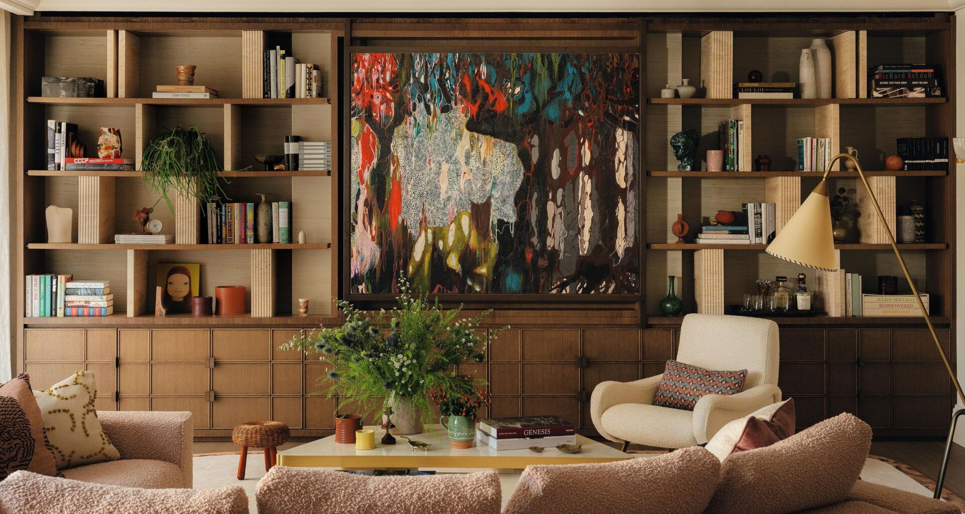 a layered living with a large wooden media wall and abstract artwork hiding the TV