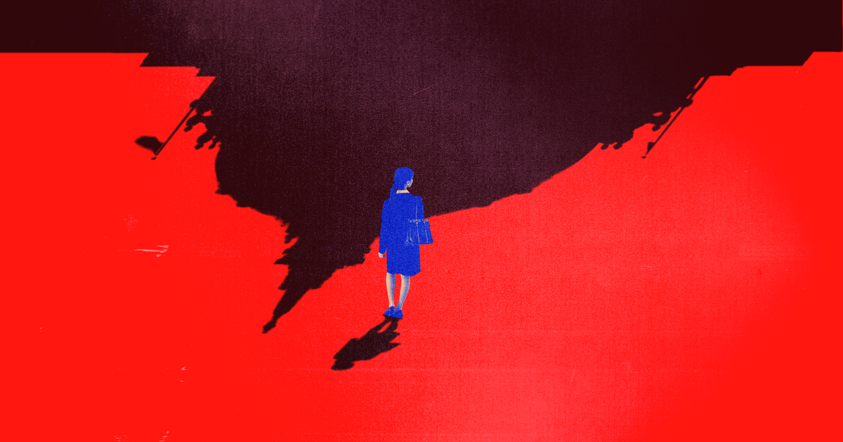 A blue-clad person stands alone at the edge of a large, irregularly shaped black shadow on a vivid red ground.