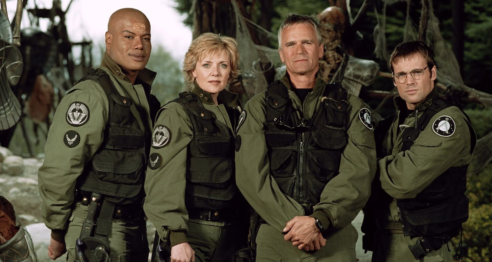 Screenshot from Stargate SG-1 showing the four main cast members in military attire.