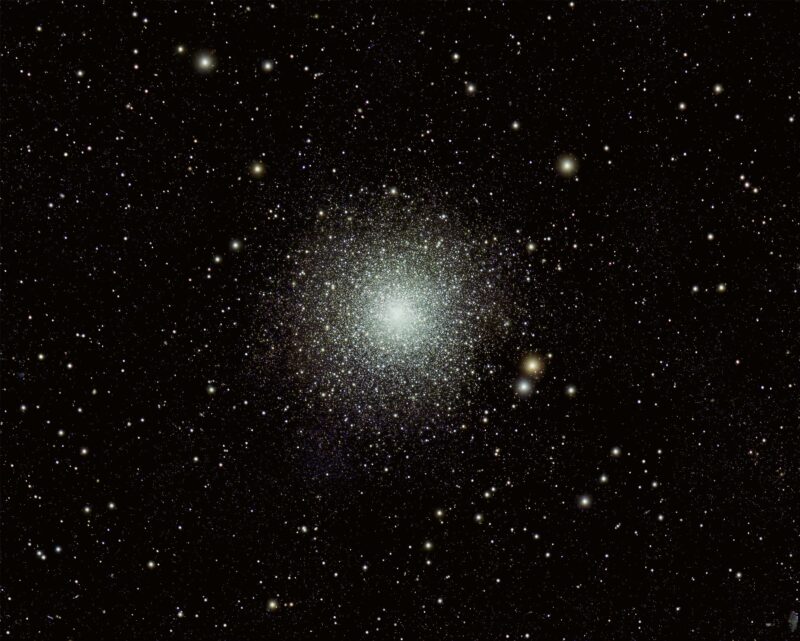 Deep-sky photos: A spherical cluster with a myriad bright stars, densely white at the center and less dense at the edges.