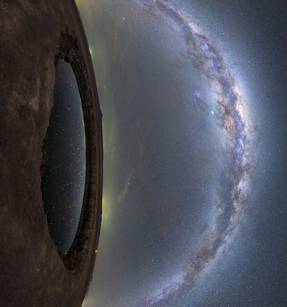 The image shows land on the left and a star filled
sky on the right. Prominent in the sky is the band of our
Milky Way Galaxy. On the left is a small circular lake 
that reflects some of the stars in the sky. Together, 
the land and lake look like an eye lookout out at the 
Milky Way. 
Please see the explanation for more detailed information.