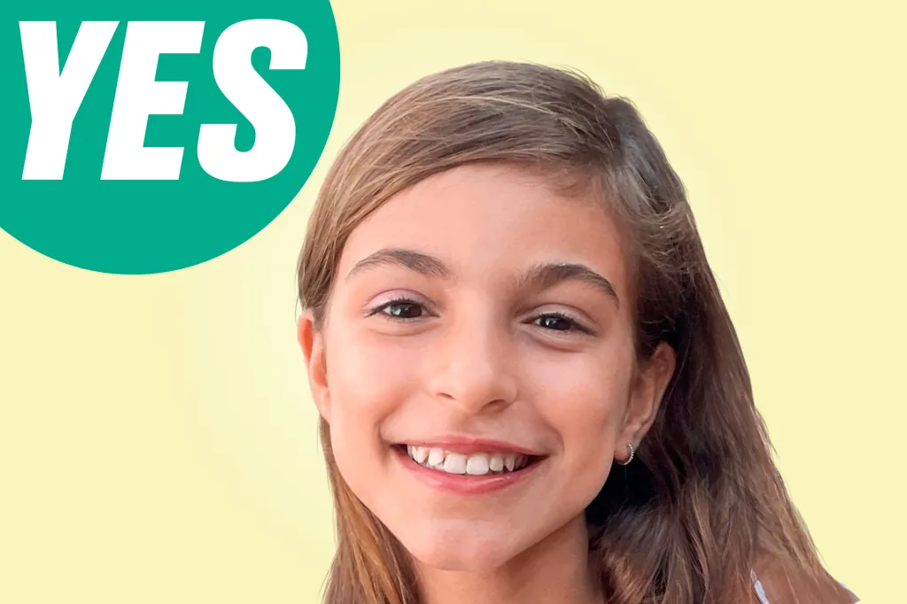 A smiling girl looks at the camera, with a green speech bubble that says “YES.”