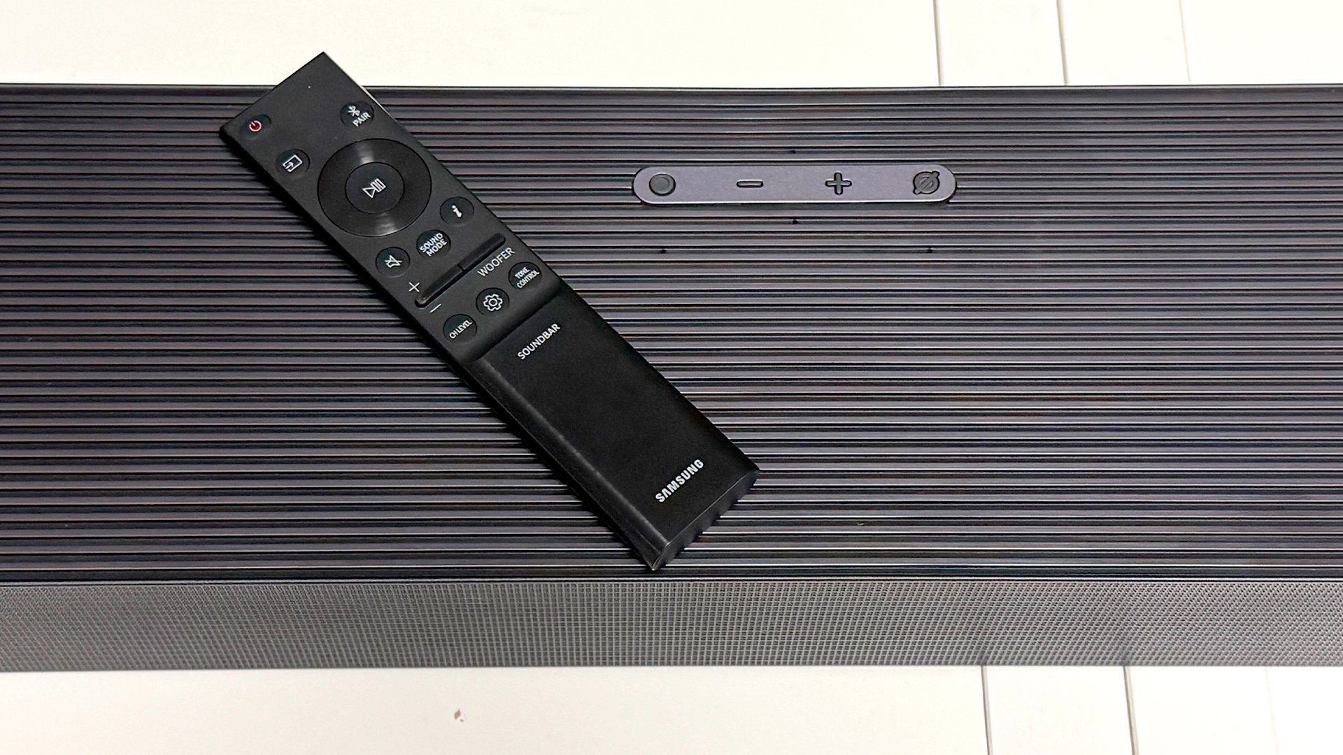 Samsung HW-Q990H soundbar package remote control on top of soundbar