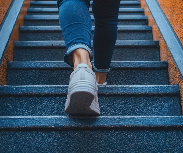 feet of person walking up outdoor steps