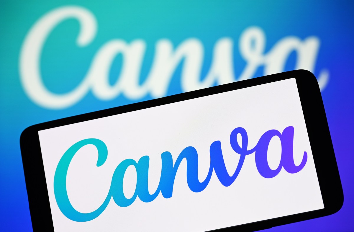 In this photo illustration, the Canva logo is seen on a smartphone and in the background.