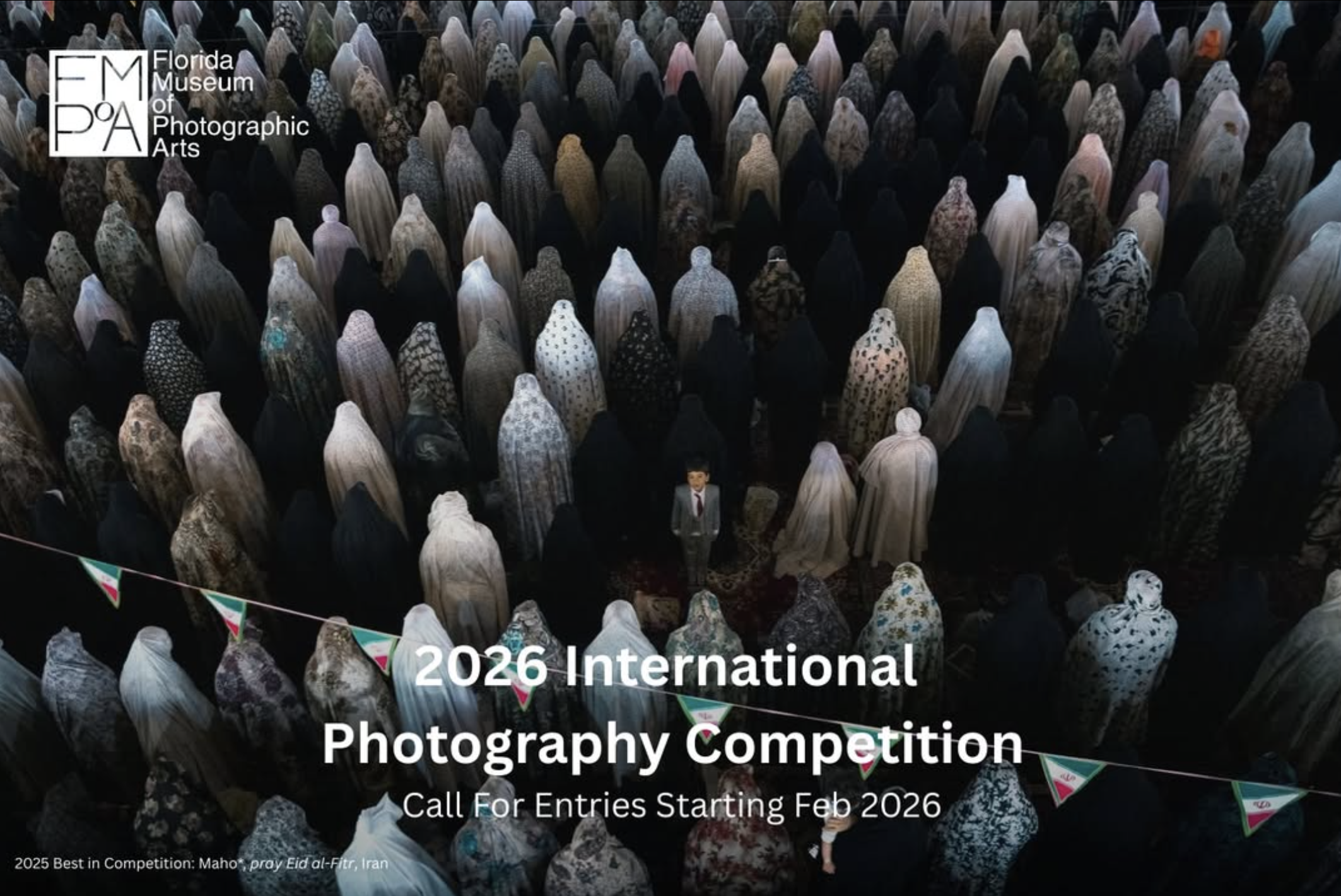 Aerial view of a large crowd of people wearing various patterned cloaks, gathered for a prayer event, with competition details overlayed