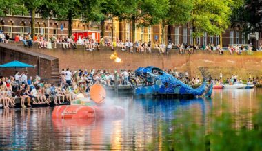 Photograph of two floating artworks sailing through a river inspired by Hieronymus Bosch.