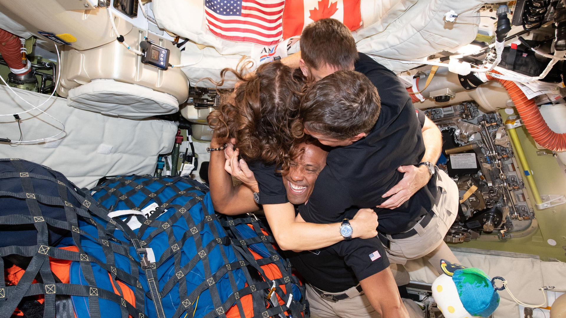 The Artemis 2 astronauts share an embrace during their historic moon mission.