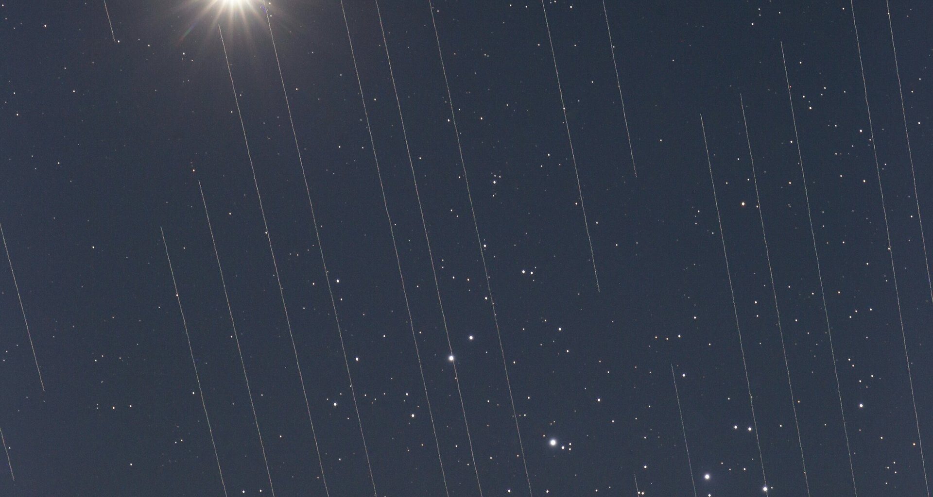 Image of Starlink satellites crossing in front of Venus and the Pleiades cluster. Credit - Torsten Hansen/IAU OAE