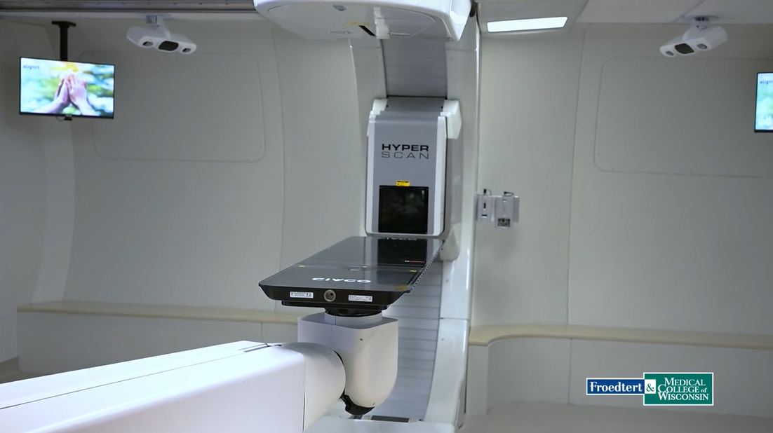 A proton therapy machine labeled HyperScan in a medical treatment room at Froedtert & Medical College of Wisconsin.