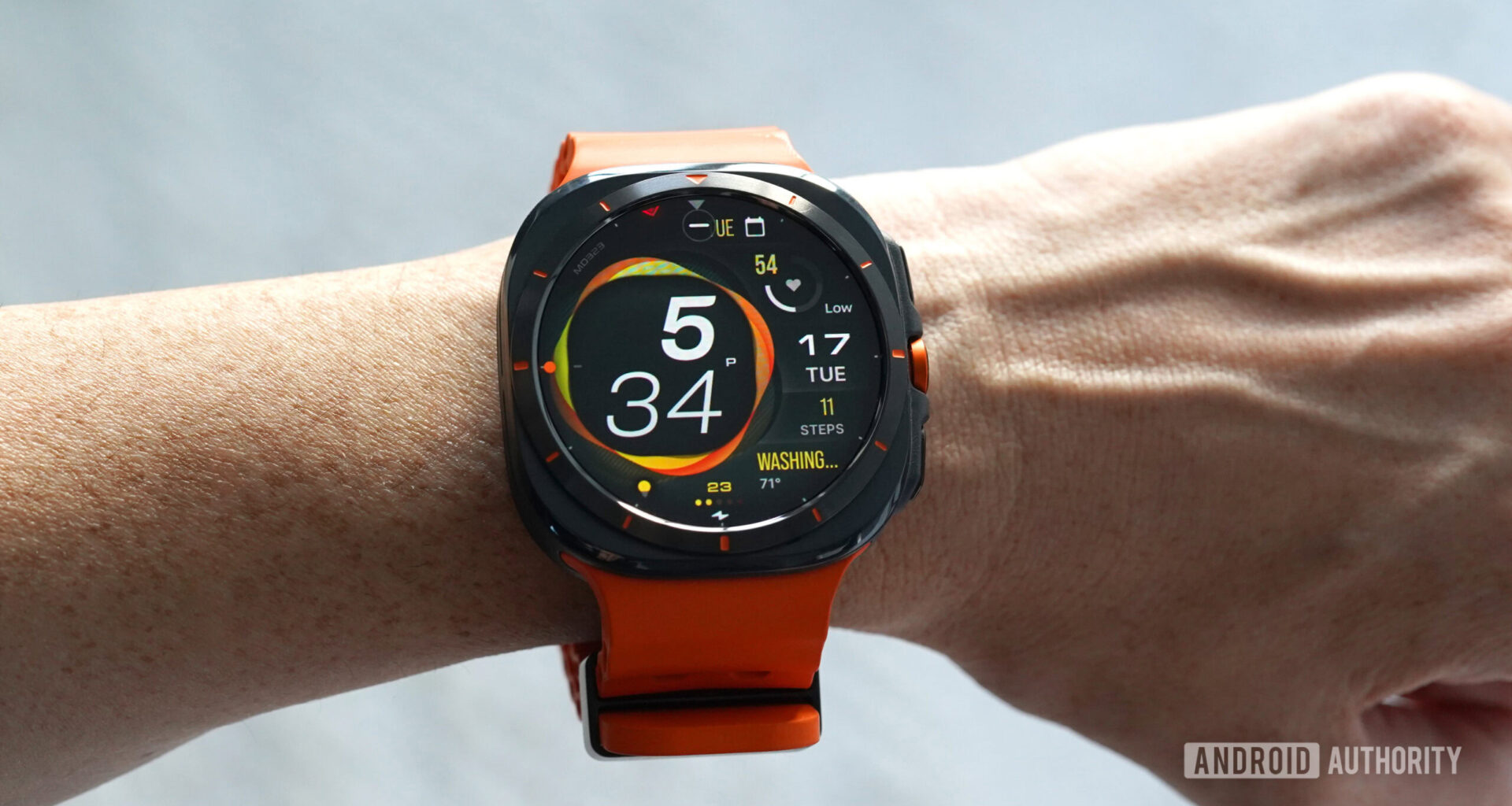 A Samsung Galaxy Watch Ultra displays the MD323 watch face