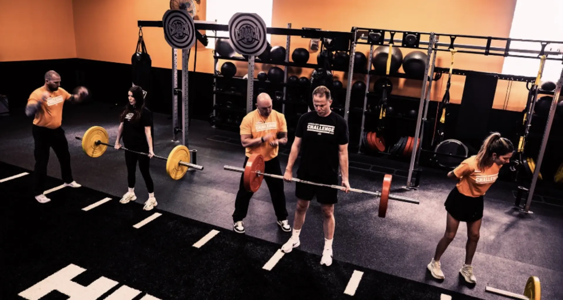 people workout inside a Crunch Fitness gym