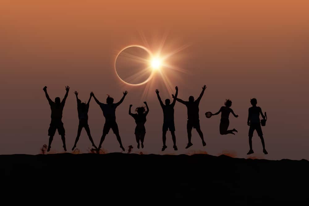 Silhouette,of,friends,jumping,at,solar,eclipse,"elements,of,this