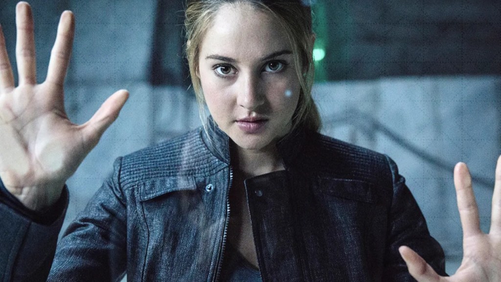 Tris pressing her hands against a barrier in Divergent