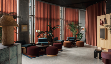 rust and brown seating and curtains in lobby of Locke Copenhagen designed by A-nrd