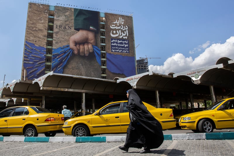 A billboard depicting an arm with an Iranian flag on the sleeve squeezing the Strait of Hormuz in Tehran, Iran. Photograph: Arash Khamooshi/The New York Times                    