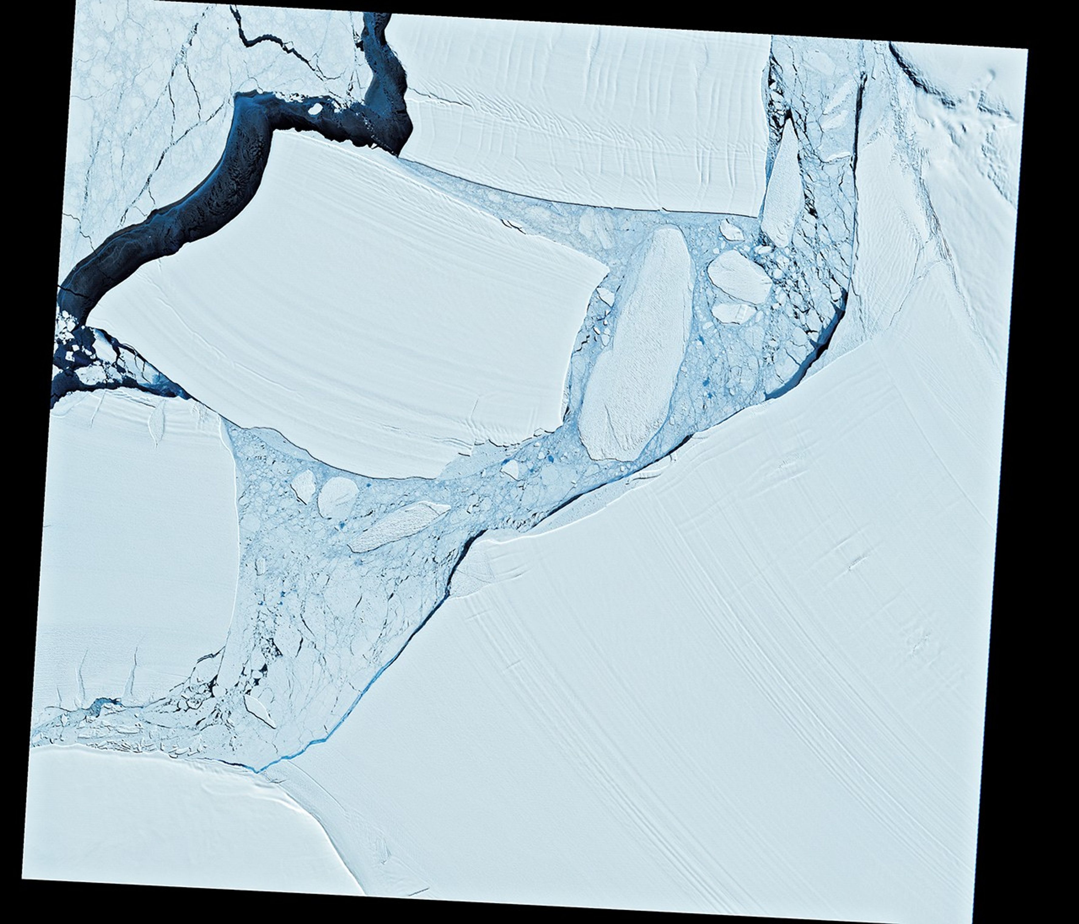Two stacked images: the top shows a massive, newly formed iceberg near Antarctica; bottom shows the same iceberg 40 years later in the South Atlantic, fragmented into many small pieces.