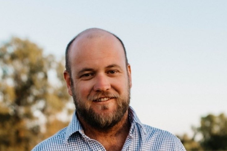 A man outside looking at camera