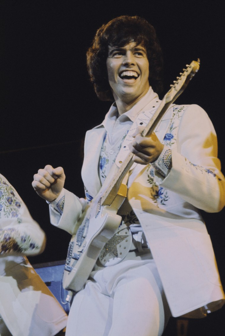 Alan Osmond performs live on stage with American family pop group The Osmonds on the British leg of their European tour, Oct. 1973.
