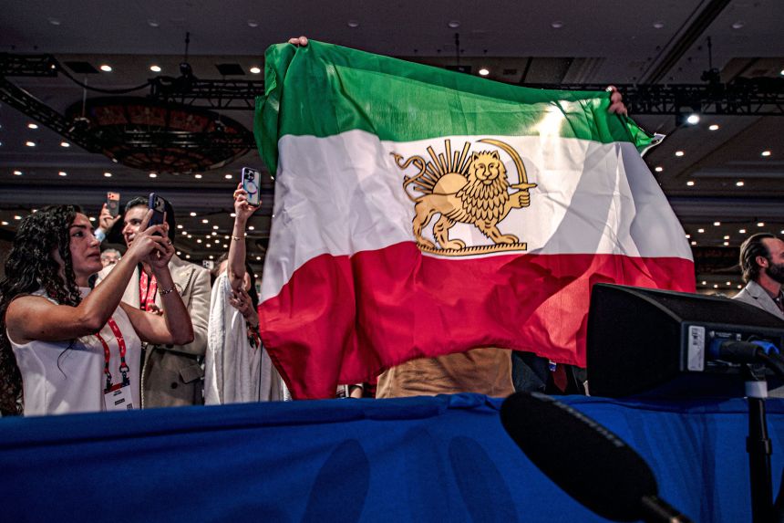 People wave a pre-Islamic Revolution flag of Iran, at CPAC 2026 in Grapevine, Texas on March 28.