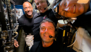 Midway through their lunar observation period on Monday, April 6, 2026, the Artemis II crew members, NASA astronauts Reid Wiseman, Victor Glover, Christina Koch, and CSA (Canadian Space Agency) astronaut Jeremy Hansen, pause to turn the camera around for a selfie inside the Orion spacecraft.