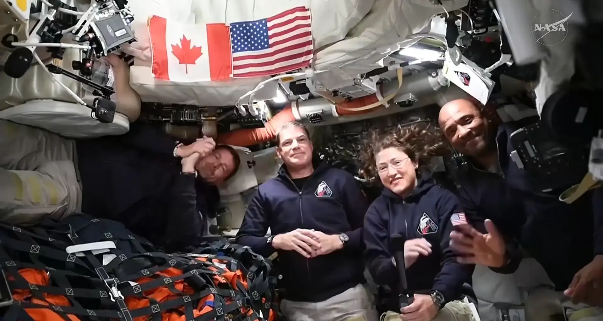 Astronauts inside the Orion capsule for the Artemis II mission posed together for a photo.