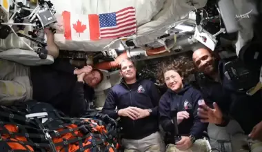 Astronauts inside the Orion capsule for the Artemis II mission posed together for a photo.