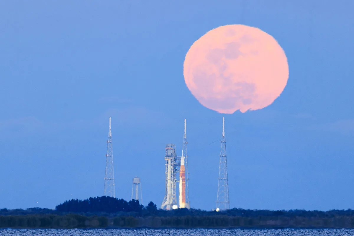 The 1 February 2026 full Moon above the Artemis II Space Launch System, Kennedy Space Center, Florida, USA, 1 February 2026, 18:04 EST. Captured by Chengcheng Xu, Tianyao Yang. Equipment: Canon EOS R5 Mark II camera, Canon RF 200–800mm lens. Exposure: ISO 500, f/9, 1/40s