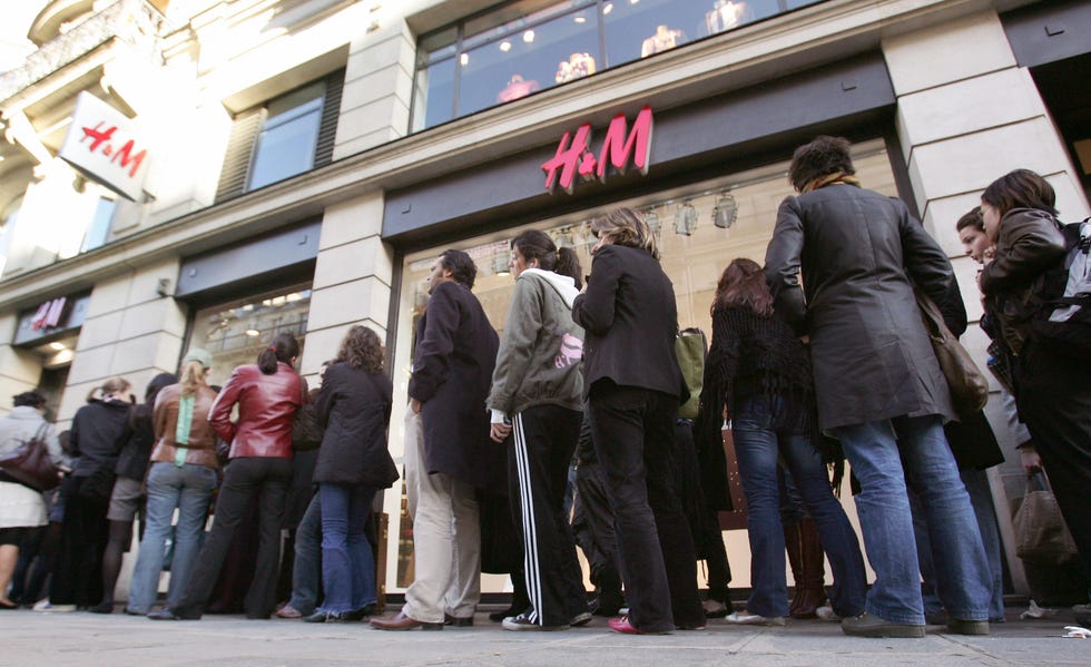 paris, france: customers queue 10 november 2005 in front of hennes and mauritz (h m) outlet for the launch of british designer stella mccartneys fashion line at one of the paris stores of the swedish mass market retailer. fashion lovers are expected to make a rush to buy the new collection sold in 22 countries. afp photo jean pierre muller (photo credit should read jean pierre muller/afp via getty images)