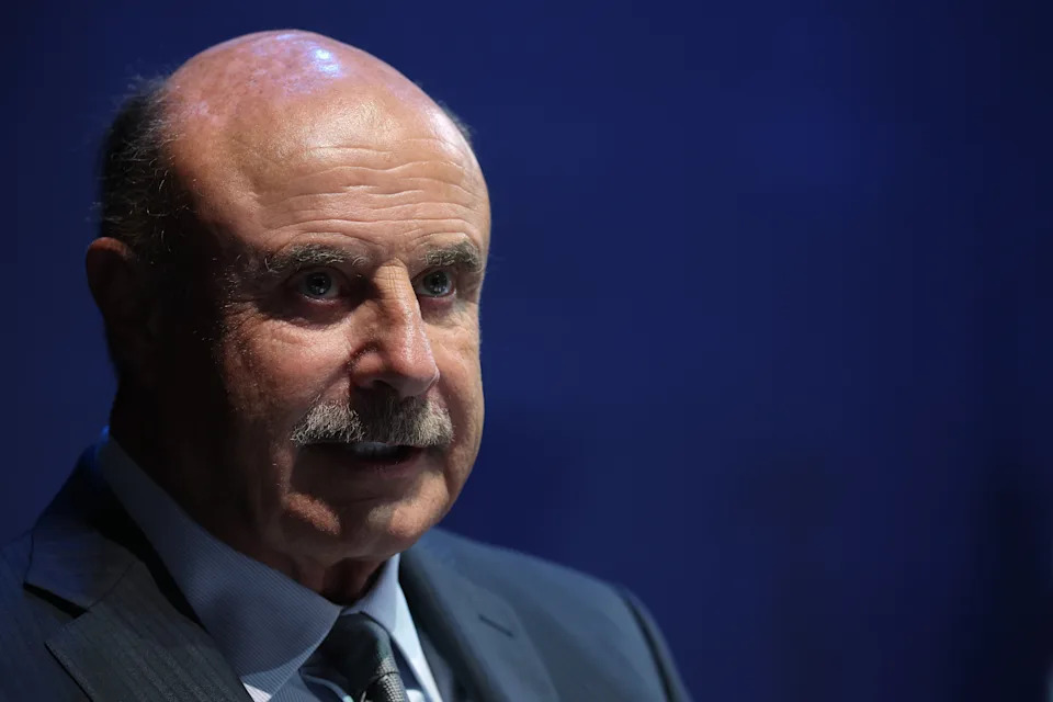 Man in suit and tie with a serious expression at a formal event