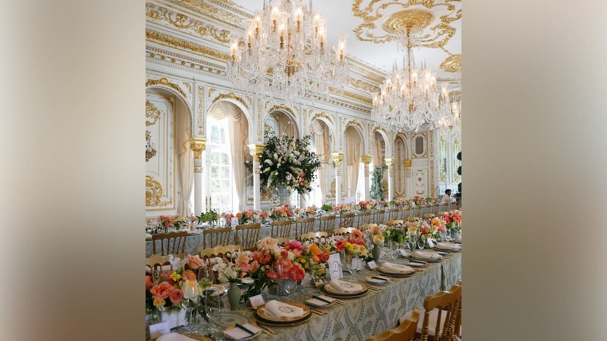 Elegant bridal shower table setup in a grand ballroom with crystal chandeliers for Bettina Anderson.