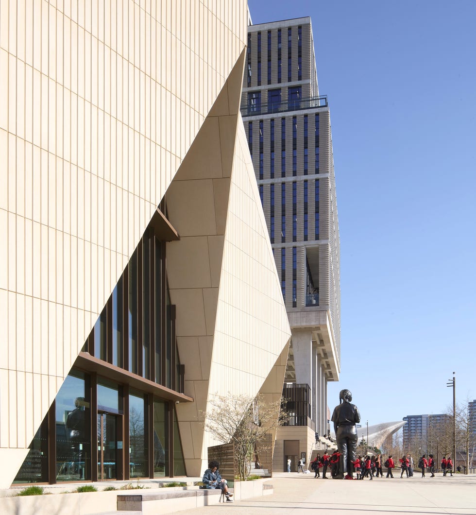 Modern architectural structures with a person sitting on a bench.