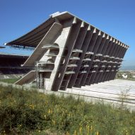 Exterior of Braga Municipal Stadium showing the angular concrete stand with stepped terraces and structural supports