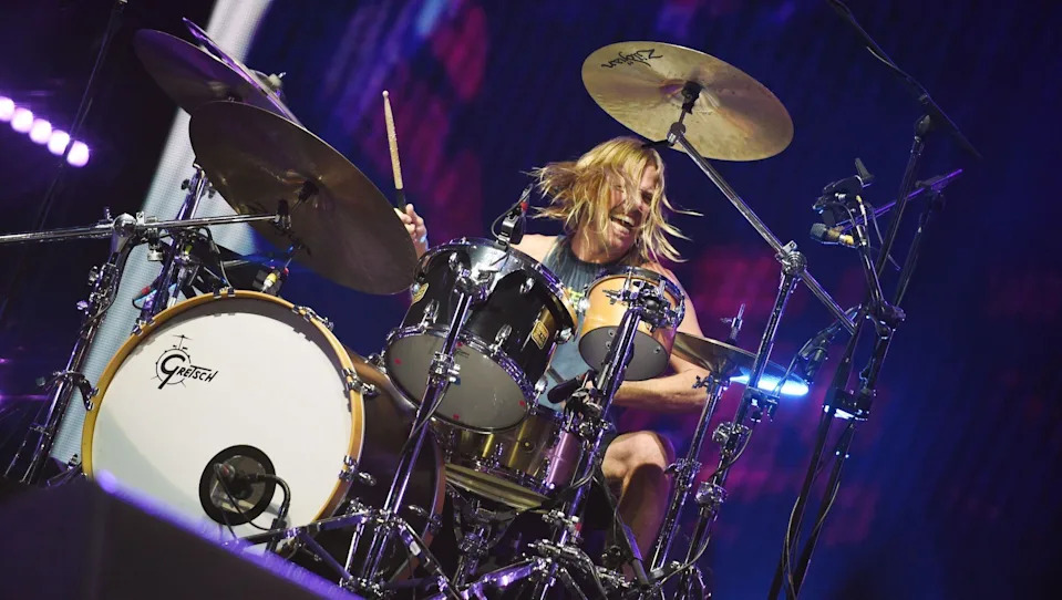 Taylor Hawkins smiles while playing the drums onstage at the BBC's Big Weekend festival in Norwich, 2015