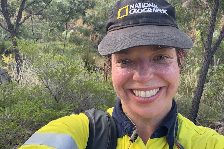 selfie of a young woman in the NT bush wearing a Fluro shirt and cap